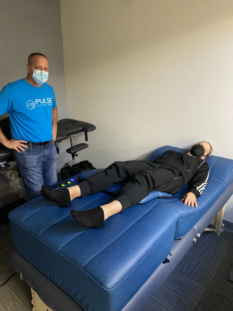 Pemp patient laying on bed with man standing beside her.