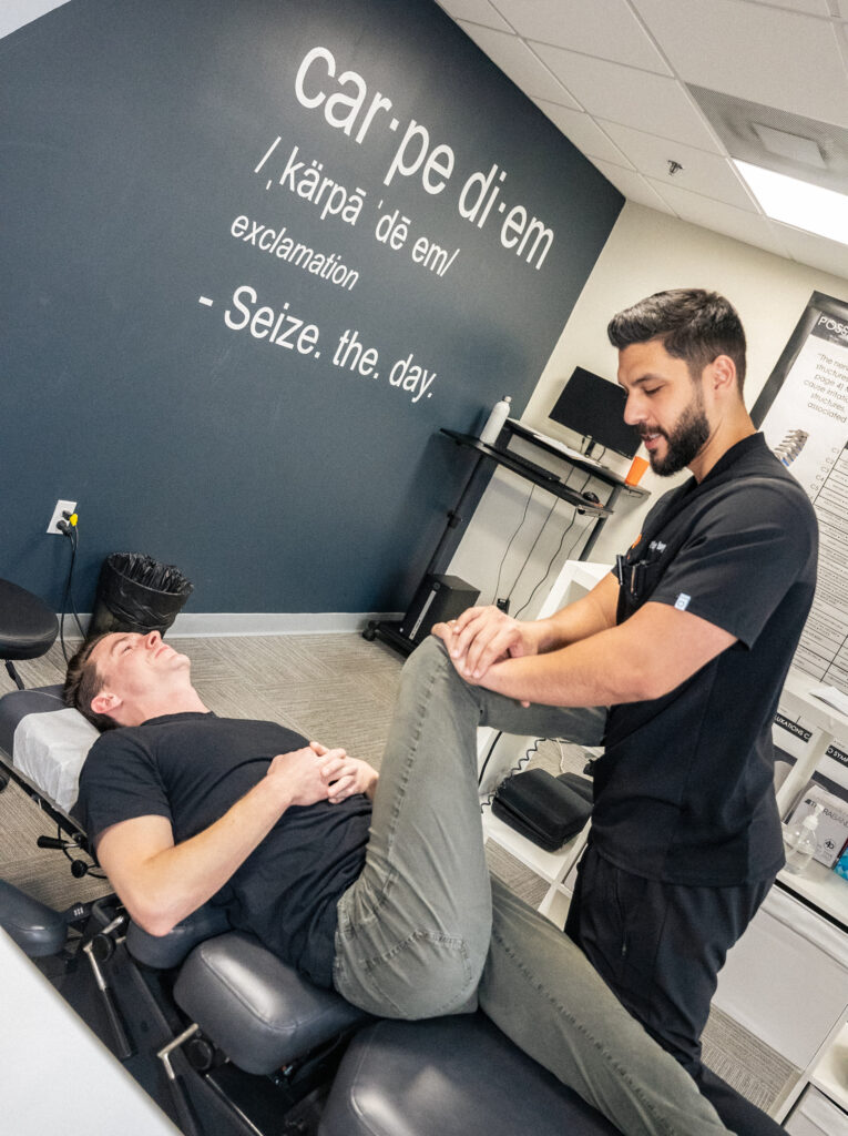 Chiropractor holding patient let up to apply pressure to increase mobility.