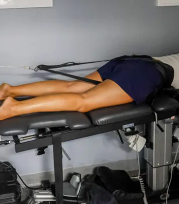 Patient receiving spinal decompression therapy to relieve lower back pressure and support recovery